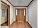 View of the entryway with wooden door and trim on walls and ceiling at 617 Rock Springs Rd, Lawrenceville, GA 30043