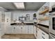 Bright kitchen featuring white cabinets, dark countertops and hardwood floors at 617 Rock Springs Rd, Lawrenceville, GA 30043