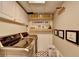 Modern laundry room featuring white cabinets, subway tile backsplash, and patterned floors at 617 Rock Springs Rd, Lawrenceville, GA 30043