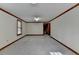Spacious living room with carpeted floors, wood trim, and a window for natural light at 617 Rock Springs Rd, Lawrenceville, GA 30043