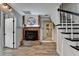 Welcoming living room featuring a brick fireplace, staircase, and access to other rooms in the home at 617 Rock Springs Rd, Lawrenceville, GA 30043