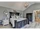 Spacious main bedroom featuring a large bed, modern lighting and dark wood accents at 617 Rock Springs Rd, Lawrenceville, GA 30043
