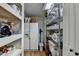 Spacious pantry with shelving and appliances, including a refrigerator and wire rack storage at 617 Rock Springs Rd, Lawrenceville, GA 30043