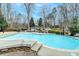 Large in-ground pool surrounded by patio, greenery, and seating, offering a relaxing outdoor space at 617 Rock Springs Rd, Lawrenceville, GA 30043