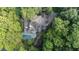 Aerial view of the home surrounded by mature trees and a beautiful pool at 760 River Gate Dr, Atlanta, GA 30350