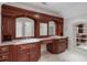 Elegant bathroom features custom wood cabinetry, dual sinks, marble countertops, and tiled floors at 760 River Gate Dr, Atlanta, GA 30350