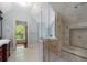 Bright bathroom featuring tiled walls, glass shower, and natural light from the window at 760 River Gate Dr, Atlanta, GA 30350