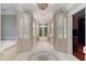 Luxury bathroom with dual vanities, mosaic floor tile, and soaking tub at 760 River Gate Dr, Atlanta, GA 30350