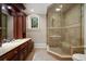 Bathroom featuring a tiled shower with a built-in seat and a dark wood vanity at 760 River Gate Dr, Atlanta, GA 30350