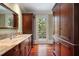 Bathroom with granite countertops, custom cabinets, and access to outdoor patio at 760 River Gate Dr, Atlanta, GA 30350