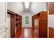A large walk-in closet provides ample storage space with custom shelving, cabinets, and wood floors at 760 River Gate Dr, Atlanta, GA 30350