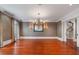 Dining room featuring hardwood floors, a chandelier, and decorative wallpaper, with stairs in view at 760 River Gate Dr, Atlanta, GA 30350