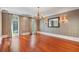 Formal dining room featuring hardwood floors, decorative wallpaper, and an elegant chandelier at 760 River Gate Dr, Atlanta, GA 30350