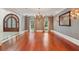 Formal dining room showcasing hardwood floors, elegant lighting, and a door leading to another room at 760 River Gate Dr, Atlanta, GA 30350