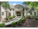Elegant home with a stone walkway, manicured shrubs, and a charming balcony above the arched entryway at 760 River Gate Dr, Atlanta, GA 30350