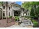 Elegant home with a stone walkway, manicured shrubs, and a charming balcony above the arched entryway at 760 River Gate Dr, Atlanta, GA 30350