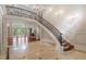 Elegant foyer with a curved staircase, decorative iron railings, and a view into the living room at 760 River Gate Dr, Atlanta, GA 30350