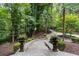 Landscaped stone pathway leading to a home with lush trees and manicured bushes at 760 River Gate Dr, Atlanta, GA 30350