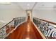 Hallway featuring hardwood floors, ornate wrought iron railing, and domed ceiling at 760 River Gate Dr, Atlanta, GA 30350