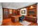 Elegant home office with hardwood floors, custom built-ins, and a large wooden desk at 760 River Gate Dr, Atlanta, GA 30350