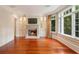 Living room with a cozy fireplace, built-in cabinets, and abundant natural light at 760 River Gate Dr, Atlanta, GA 30350