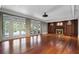 Expansive living area featuring wood floors, a fireplace, and multiple doors to the backyard at 760 River Gate Dr, Atlanta, GA 30350
