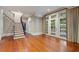 Spacious room featuring hardwood floors, a staircase, and glass doors to outdoor space at 760 River Gate Dr, Atlanta, GA 30350