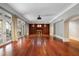 Open-concept living room with hardwood floors, a fireplace, and french doors to outdoor space at 760 River Gate Dr, Atlanta, GA 30350