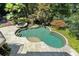 Aerial view of a luxurious kidney-shaped pool and spa surrounded by mature trees at 760 River Gate Dr, Atlanta, GA 30350