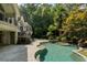 Inviting backyard pool with stone patio, spa, lush landscaping, and access to the home at 760 River Gate Dr, Atlanta, GA 30350