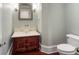 This powder room features a marble countertop, unique bowl sink, and decorative mirror at 760 River Gate Dr, Atlanta, GA 30350