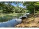 Scenic view of the river bordered by lush trees and a grassy bank at 760 River Gate Dr, Atlanta, GA 30350