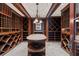 Elegant wine cellar with custom shelving, a center island, and ambient lighting at 760 River Gate Dr, Atlanta, GA 30350
