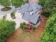 Aerial view of home featuring a well maintained yard, deck, and screened porch at 151 Overhill Point, Alpharetta, GA 30005
