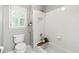 Classic bathroom with white tile, a shower-tub combo, and a natural-light filled window at 151 Overhill Point, Alpharetta, GA 30005