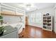 Bright bedroom featuring a bunk bed, white furniture, wood floors, and lots of natural light at 151 Overhill Point, Alpharetta, GA 30005