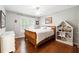 Cozy bedroom with hardwood floors, a ceiling fan, and a decorative bookcase at 151 Overhill Point, Alpharetta, GA 30005