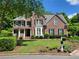 Attractive two-story brick home with a well-maintained lawn and lovely landscaping at 151 Overhill Point, Alpharetta, GA 30005
