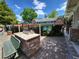Community grill area with stone accents, seating and community pool in background at 151 Overhill Point, Alpharetta, GA 30005