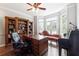 Bright home office with a large desk, bookshelves, and a comfortable chaise lounge at 151 Overhill Point, Alpharetta, GA 30005