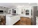 Bright open kitchen with stainless steel appliances, granite countertops, and large center island at 151 Overhill Point, Alpharetta, GA 30005
