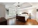 Comfortable main bedroom with a tray ceiling, ceiling fan, hardwood floors, and built-in shelving at 151 Overhill Point, Alpharetta, GA 30005