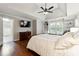 Comfortable main bedroom with tray ceilings, hardwood floors, and built-in shelving at 151 Overhill Point, Alpharetta, GA 30005