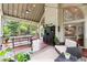 Relaxing screened porch with comfortable seating, dining, and a view of the backyard at 151 Overhill Point, Alpharetta, GA 30005