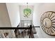Second floor landing featuring a large window, chandelier, and view of the stairs at 151 Overhill Point, Alpharetta, GA 30005