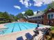 Large swimming pool with plenty of lounge chairs and umbrellas for residents at 151 Overhill Point, Alpharetta, GA 30005