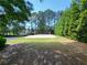Community sand volleyball court surrounded by mature trees at 151 Overhill Point, Alpharetta, GA 30005