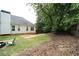 Spacious backyard featuring mature trees, a wooden fence, and a peaceful outdoor setting at 262 Devynwood Ln, Dallas, GA 30157