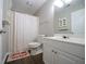 Bright bathroom features a white vanity, toilet, shower with tub and funny floor mat at 262 Devynwood Ln, Dallas, GA 30157