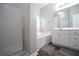 Bright bathroom featuring a soaking tub and modern vanity with ample storage at 262 Devynwood Ln, Dallas, GA 30157
